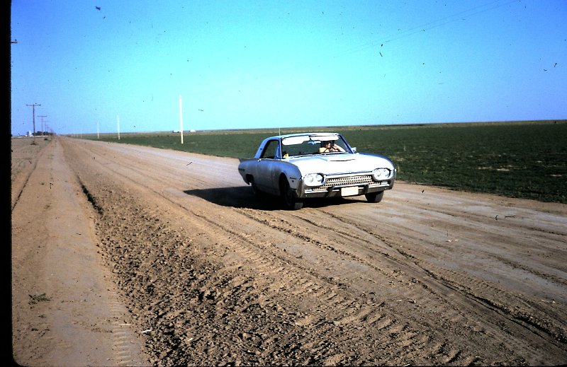 Mom driving the car on the family farm in Kansas
